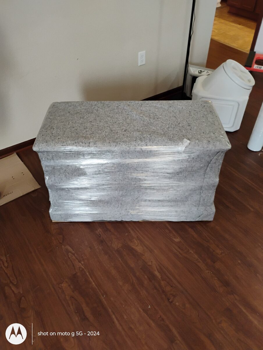 Wood furniture protected with a moving blanket and stretch wrap
